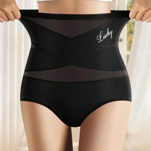 Culotte gainante taille haute noire, bande croisée en X sur le ventre, portée